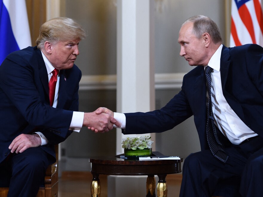 Russian President Vladimir Putin and then President Donald Trump shake hands before a meeting in Helsinki, on July 16, 2018. A new book by the journalist Bob Woodward reports that Trump secretly shared COVID-19 tests with Putin in 2020.