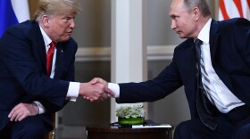 Russian President Vladimir Putin and then President Donald Trump shake hands before a meeting in Helsinki, on July 16, 2018. A new book by the journalist Bob Woodward reports that Trump secretly shared COVID-19 tests with Putin in 2020.