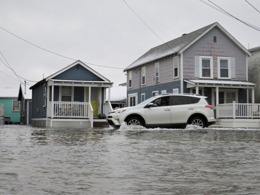 A driver heads south on Route 1A in Hampton Beach just before police closed that stretch of road due to coastal flooding Jan. 23, 2023.