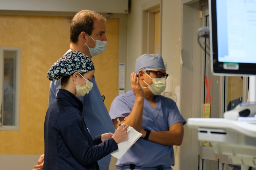 Frontlines: Catholic Medical Center staff review a COVID-19 patient's files