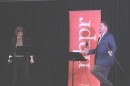 Co-Hosts Hannah McCarthy and Nick Capodice share a laugh onstage during the live taping at the Civics 101 Summit at Southern New Hampshire University on Sep. 28, 2024. Photo by Allegra Boverman