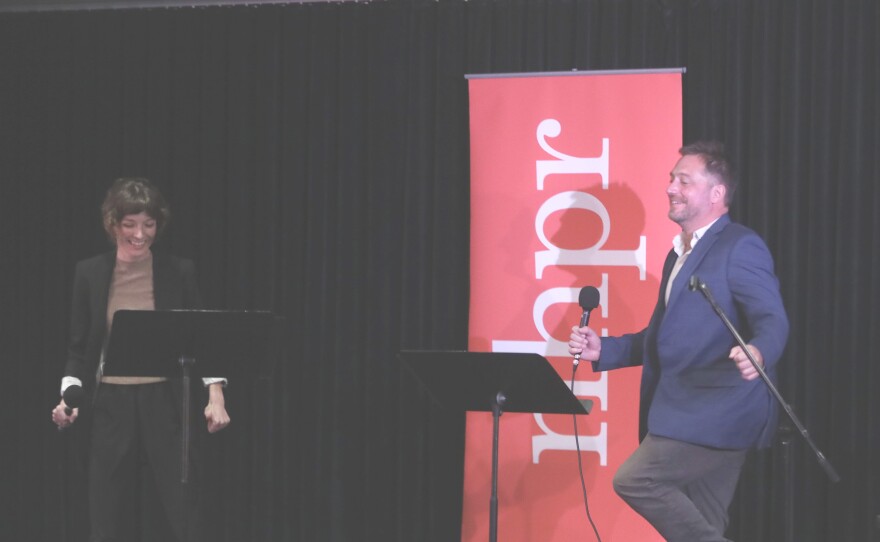 Co-Hosts Hannah McCarthy and Nick Capodice share a laugh onstage during the live taping at the Civics 101 Summit at Southern New Hampshire University on Sep. 28, 2024. Photo by Allegra Boverman