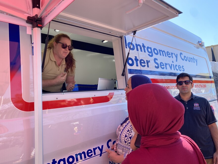 Montgomery County Commissioner Neil Makhija (right) shows off a new voting van during a fall festival.