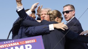 Former President Donald Trump is rushed offstage during a rally on July 13, 2024 in Butler, Pa., after an attempted assassination.