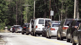  A row of cars lines up on the road outside of Diana's Baths.