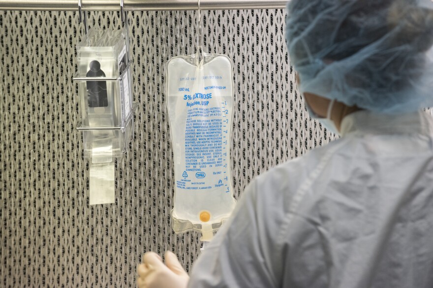 An IV bag hanging in a medical setting.