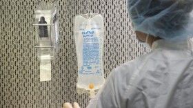 An IV bag hanging in a medical setting.