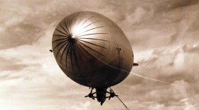 Sailors of a ground crew landing party haul down a disabled ZP2K airship at Boca Chica, Naval Air Station.