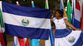 Glenda Davis of El Salvador shows off her country's flag at the Concord Multicultural Festival on Sunday, Sept. 22, 2024.