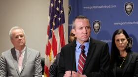 Attorney General John Formella at a podium during a press conference 