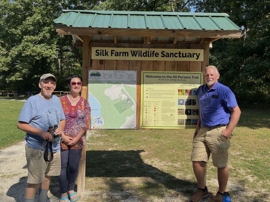 Chris Martin, Anita Fernandez and Dave Anderson stand at the NH Audubon Silk Farm Wildlife Sanctuary map.