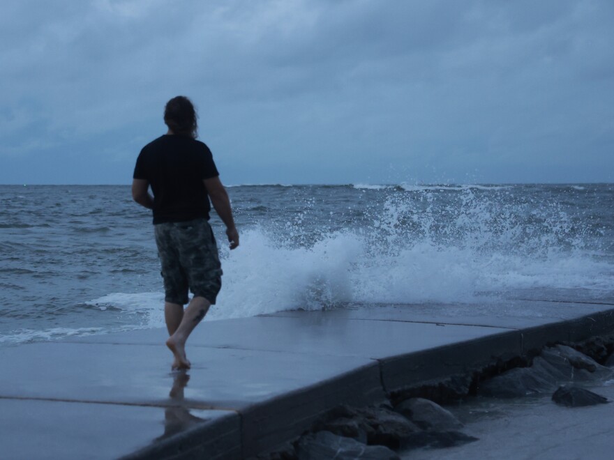 A man visits St. Pete Beach, Florida as Hurricane Helene churns offshore early Thursday. Officials are urging residents in the path of the storm to heed evacuation orders and rush all preparations to completion. 