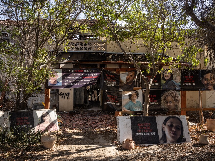 Kibbutz homes attacked in the Hamas-led assault on Oct. 7, 2023, are draped in posters noting who was killed inside the homes and others who were taken hostage.