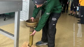 Meteorologist Alex Branton measures precipitation Aug. 9, 2023 at the Mount Washington Observatory.