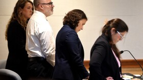 Victor Malavet stands with his lawyers as the court clerk reads the charges against him during his trial at Merrimack County Superior Court in Concord, N.H., on Aug. 26, 2024. Malavet, a former state employee is charged in connection with the attorney general’s probe of state-run youth facilities.