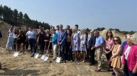 Ceremony attendees celebrate breaking ground on a new net-zero housing development in Hudson. 