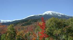 A view of snow-capped Mt. Washington and colorful foliage.