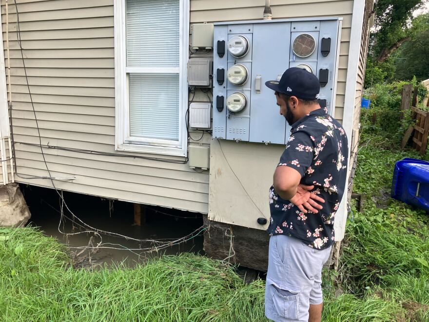 Sonny Singh views a yawning gap under his home on Second Street in Barre, where heavy currents knocked a piece of foundation off its footing. Photographed Thursday, July 11, 2024.