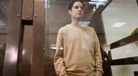 U.S. journalist Evan Gershkovich stands inside a defendants' cage during a pretrial detention hearing at the Moscow City Court in Moscow on Sept. 19, 2023. Gershkovich was detained during a reporting trip in Russia in March 2023 and accused of spying — charges that he, the U.S. government and his employer, <em>The Wall Street Journal</em>, vehemently deny. 