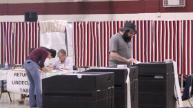 People cast ballots in a polling place