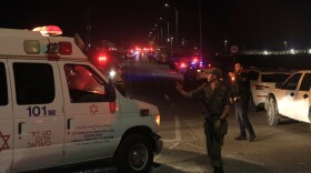 Emergency services personnel attend the scene of a drone strike launched by Hezbollah on Sunday in Binyamina, Israel.