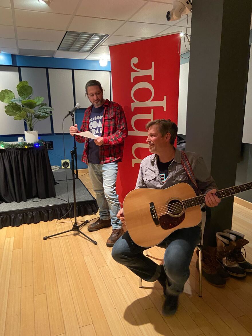 NHPR's Rick Ganley (long hair) and Peabody's Coal Train (short hair) chat before a live set during Holidays By Request VI, December 16, 2022.