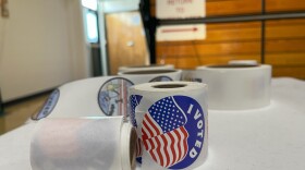 "I voted" stickers sit on a white table