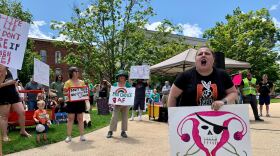 The State House plaza filled with chants, songs and plenty of protest signs.