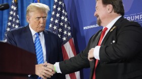 Michael McDonald, the chair of Nevada’s Republican Party, shakes hands with former President Donald Trump at a January event for Trump’s reelection campaign in Las Vegas. McDonald is one of this year’s 14 presidential electors who are linked to efforts to reverse Trump’s 2020 defeat.