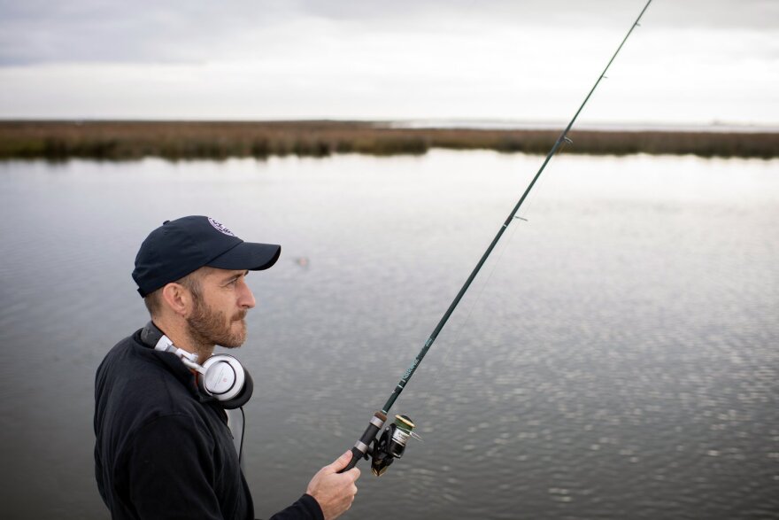 Writer Boyce Upholt fishes at Lake St. Catherine in New Orleans, La.