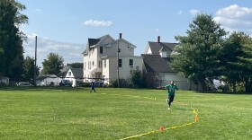 A Boston All Stars player runs after the ball during a cricket match at Manchester's Prout Park on Saturday.