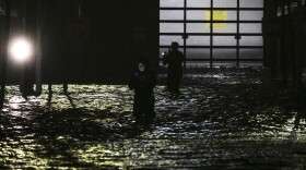 Chris Williams runs through a rain storm as he packs his car to evacuate his apartment in Fort Myers, Fla., on Wednesday before Hurricane Milton's arrival. People are waiting to assess the damage after the storm came ashore.