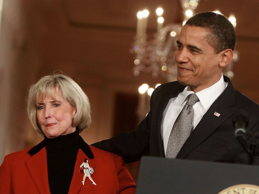 President Barack Obama stands with Lilly Ledbetter before signing the Lilly Ledbetter Fair Pay Act during an event in the East Room of the White House on Jan. 29, 2009.