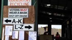 Signs outside the Lee transfer station during the 2021 town election instruct voters to wear their masks and shut off their engines.