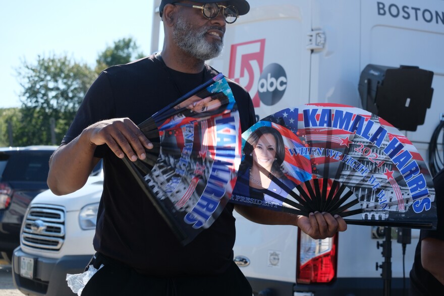 A vendor selling Harris-branded fans during a hot afternoon rally at Throwback Brewery.