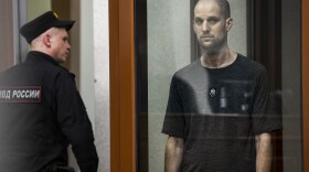 <em>Wall Street Journal</em> reporter Evan Gershkovich stands in a glass cage of a Russian courtroom on  July 19. A Russian court convicted Gershkovich on espionage charges that his employer and the U.S. have rejected as fabricated. He was sentenced to 16 years in prison after a secretive and rapid trial. 