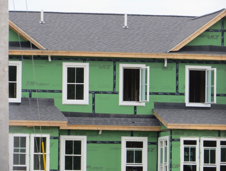 The exterior of new residential construction in Rye, NH, shows an unfinished home with exposed siding