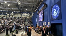 Students in the University of New Hampshire's class of 2024 walk across the stage at graduation.