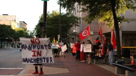 Protestors stand outside Manchester City Hall the evening of Tuesday, Sept. 3, 2024 to demand the city change its policy of using law enforcement to handle unhoused people. This follows an incident on Aug. 12 where officers were recorded saying they would start a "manhunt" for an unhoused person.