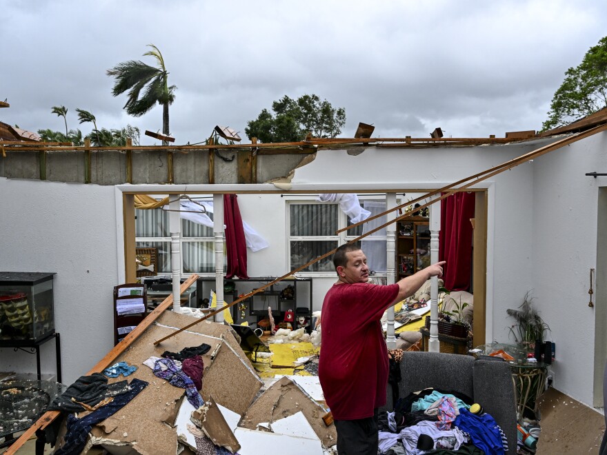 Robert Haight looks around his destroyed house after it was hit by a reported tornado in Fort Myers, Florida, as Hurricane Milton approaches.