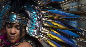 An Aztec heritage dancer wears traditional regalia during the Latino Heritage Festival in Des Moines, Iowa Sept. 26, 2015.