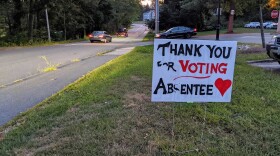 A sign along the road in Durham reads, "Thank you for voting absentee."