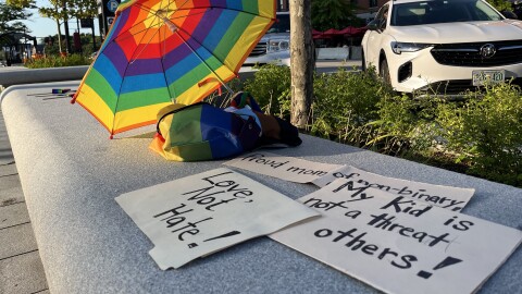 Signs from a rally outside of the New Hampshire State House, held two days after Gov. Chris Sununu signed new restrictions on gender-affirming surgeries and transgender girls' participation in school sports.