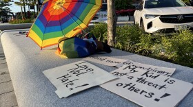 Signs from a rally outside of the New Hampshire State House, held two days after Gov. Chris Sununu signed new restrictions on gender-affirming surgeries and transgender girls' participation in school sports.