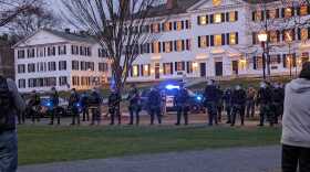 State police line the perimeter of the Dartmouth Green as a crowd gathered to protest Israel’s war in Gaza Wednesday night.