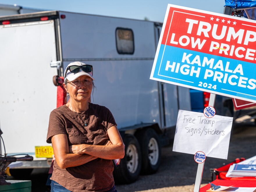 Ina Noggle poses for a portrait next to the Arizona GOP’s table at the Gallup Flea Market.