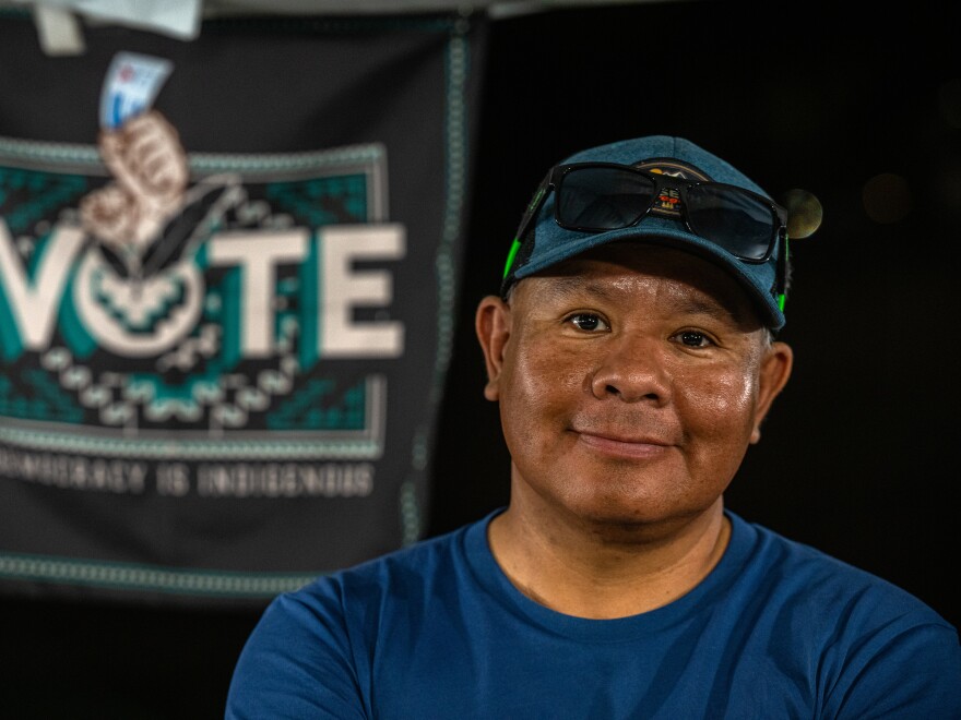 Kevin Jackson poses for a portrait in his vendor booth at the Phoenix Indian Center’s Social Powwow and Gourd Dance.