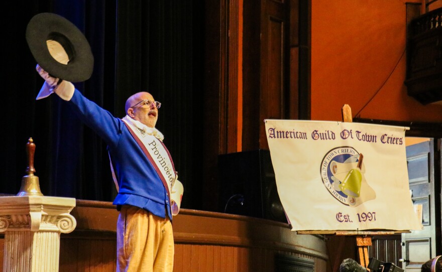 Provincetown town crier Daniel Gómez Llata speaks to the audience inside Town Hall during the Town Crier Competition.