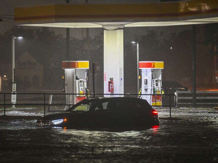 A vehicle is stranded on a water-flooded street after Hurricane Milton made landfall in Brandon, Florida on Oct. 9, 2024.