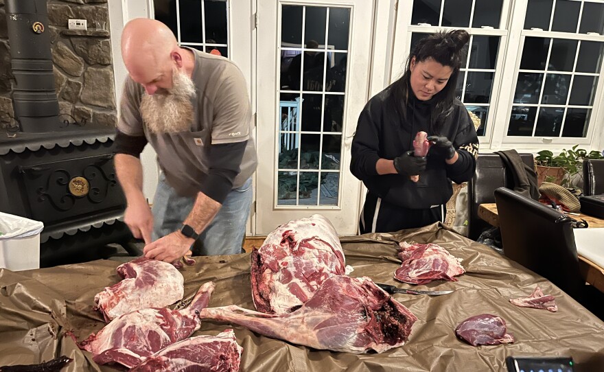 Dorothy Ren (right) learns how to butcher a deer from her hunting mentor Brian Bird (left).